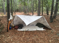 Some guild members use canvas tarp shelters while camping.